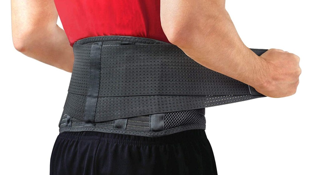 A person pulling the side straps of a black back support belt around his waist.