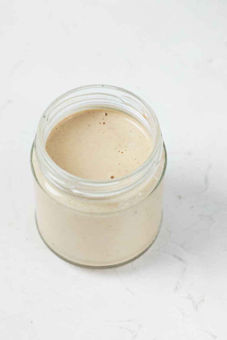 An overhead image of a creamy balsamic Dijon tahini dressing.